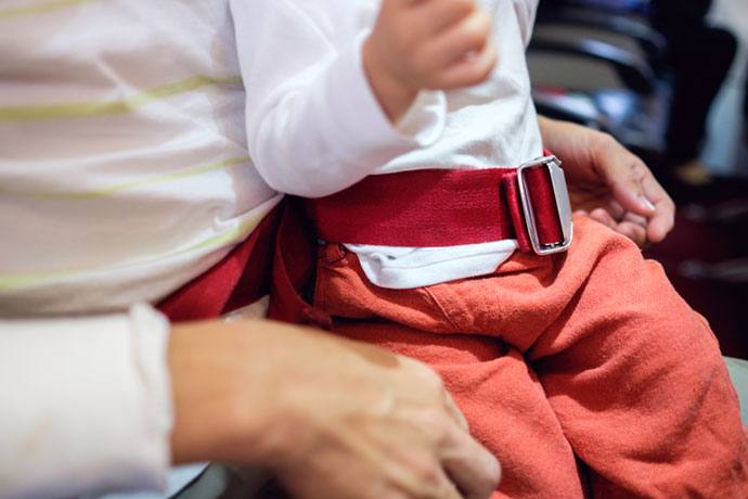 flying with infant on lap frontier